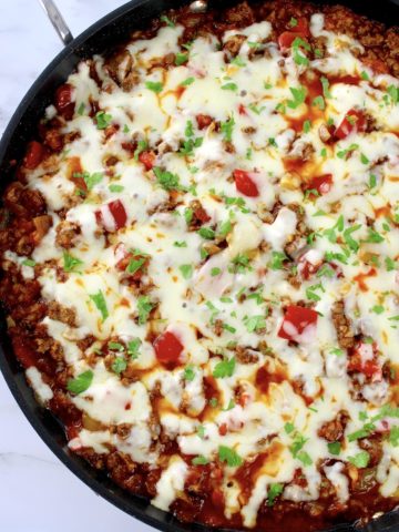 Stuffed Pepper Skillet in pan with melted cheese and chopped parsley on top